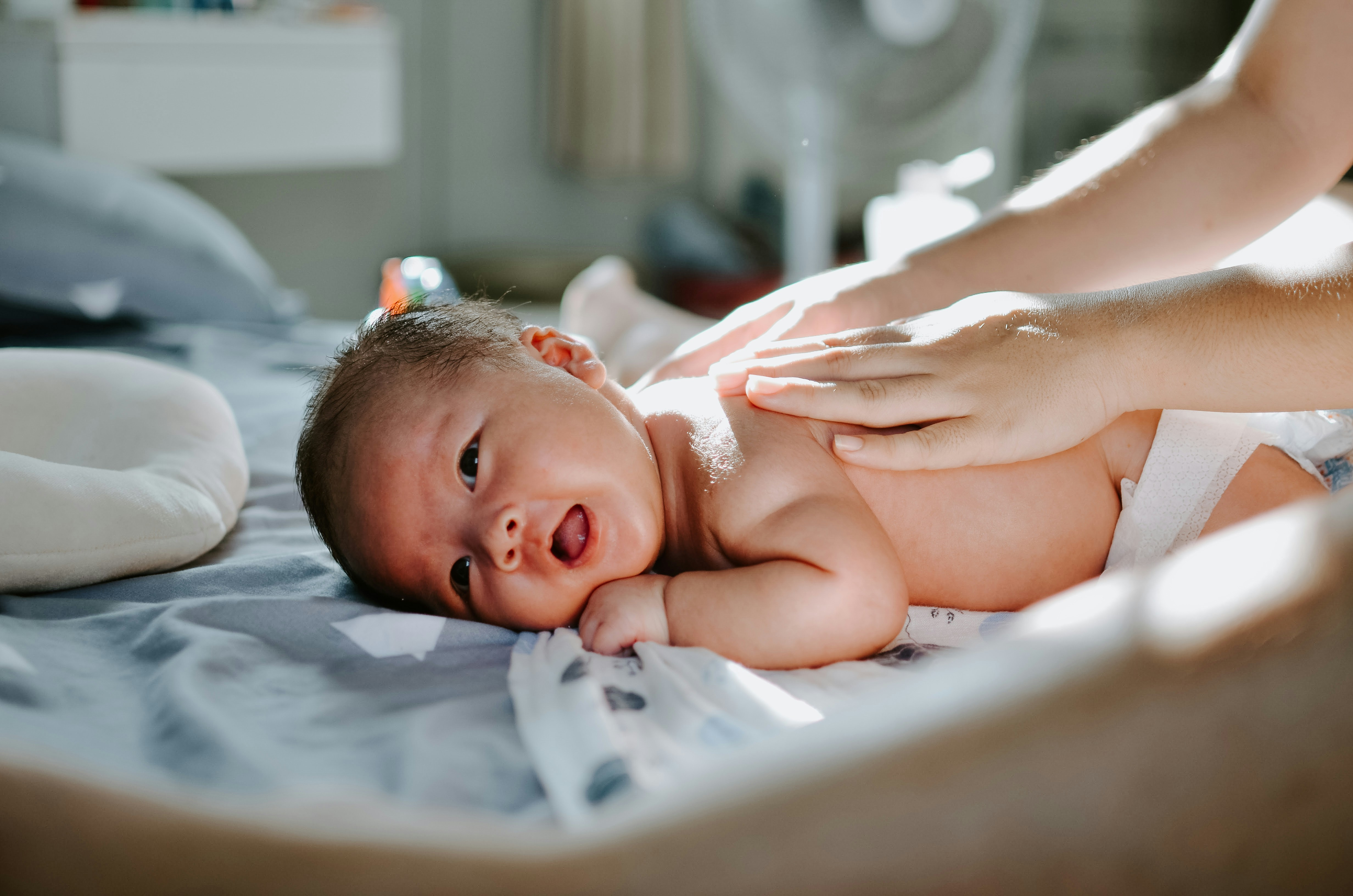 baby laying on their tummy getting a massage from a doula