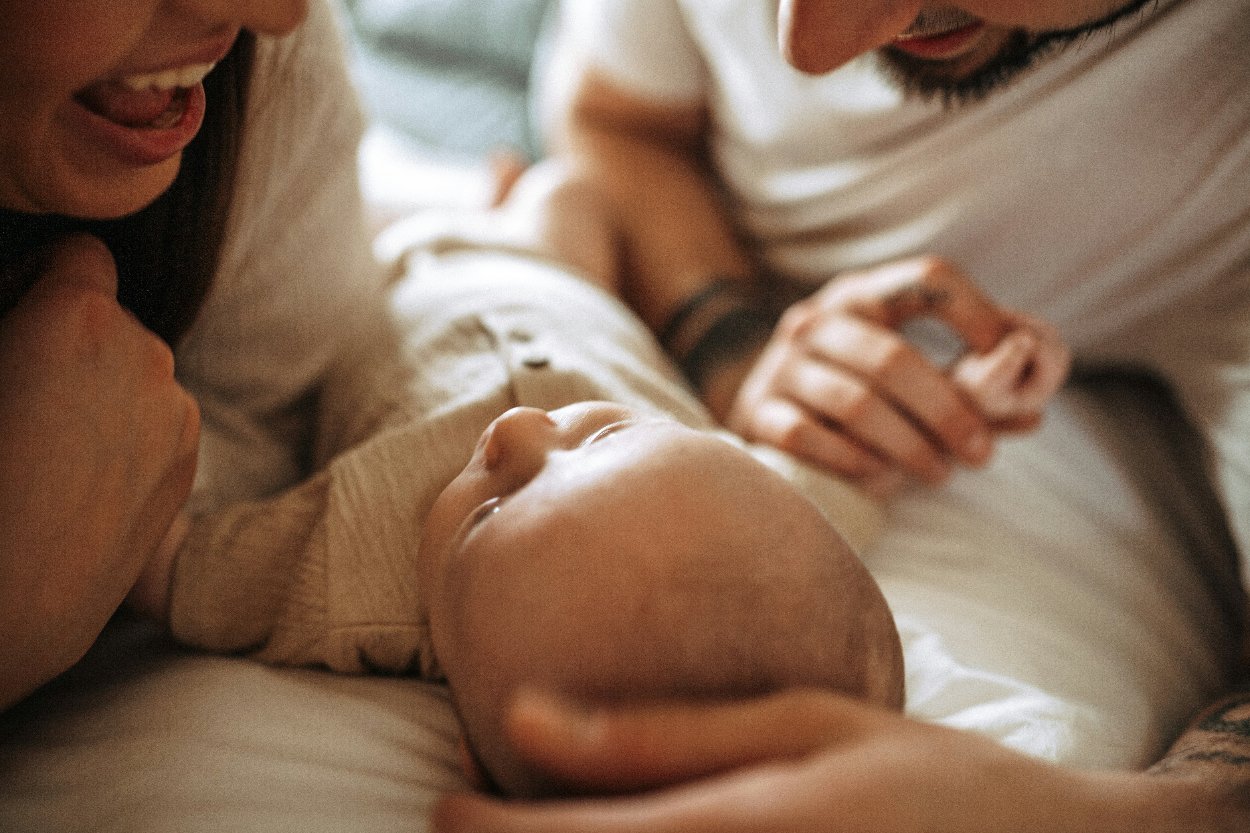 two parents looking at their newborn baby